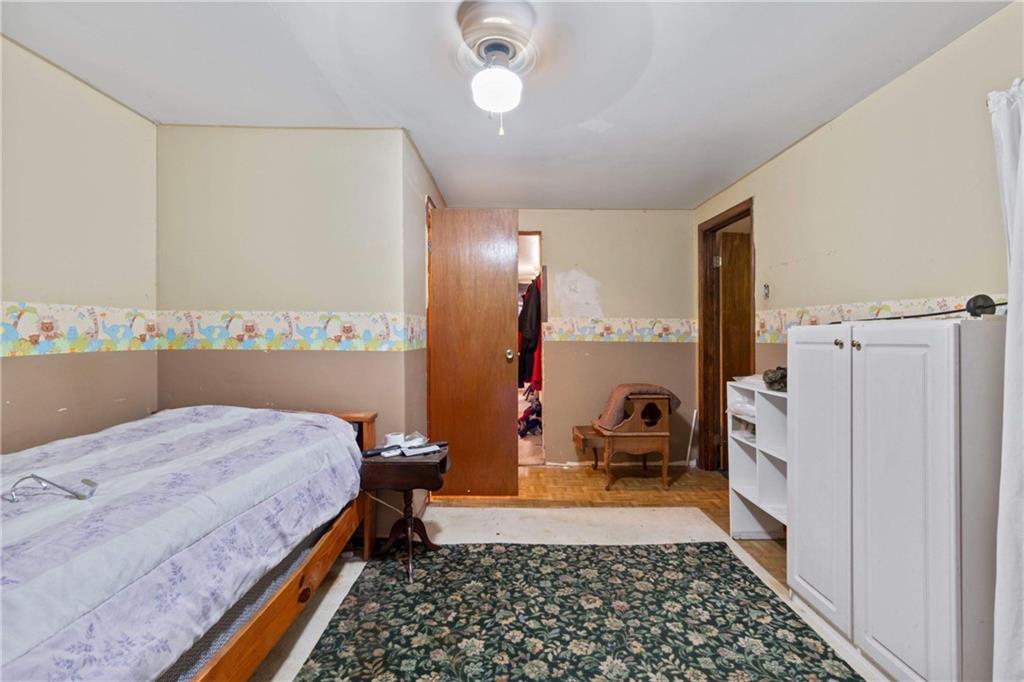 703 Indiana Avenue Monaca, PA 15061 - Photo 11 of 22 a bedroom with a bed and a chandelier