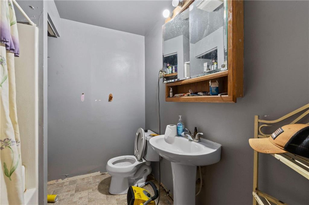 703 Indiana Avenue Monaca, PA 15061 - Photo 16 of 22 a bathroom with a sink toilet and a mirror