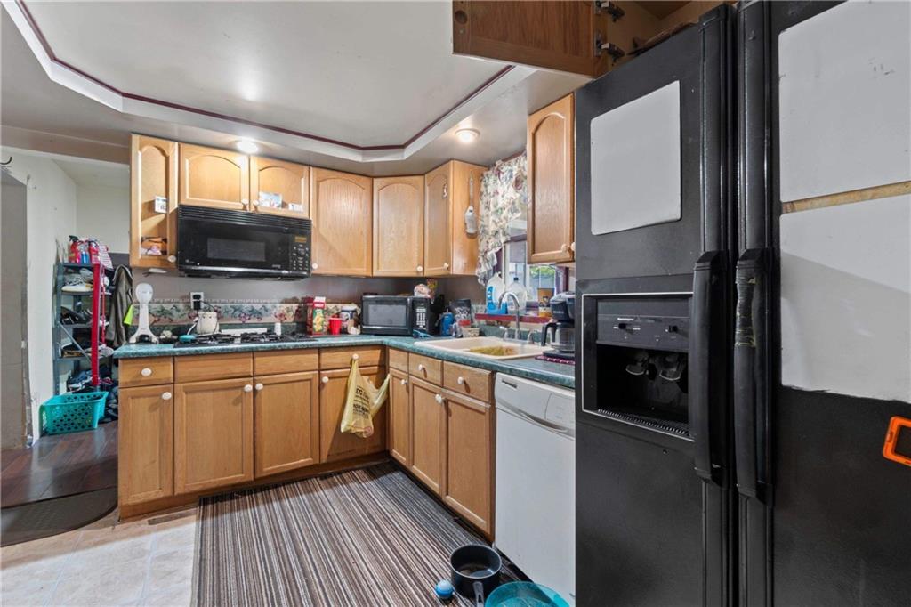 703 Indiana Avenue Monaca, PA 15061 - Photo 10 of 22 a kitchen with granite countertop a refrigerator stove top oven and sink
