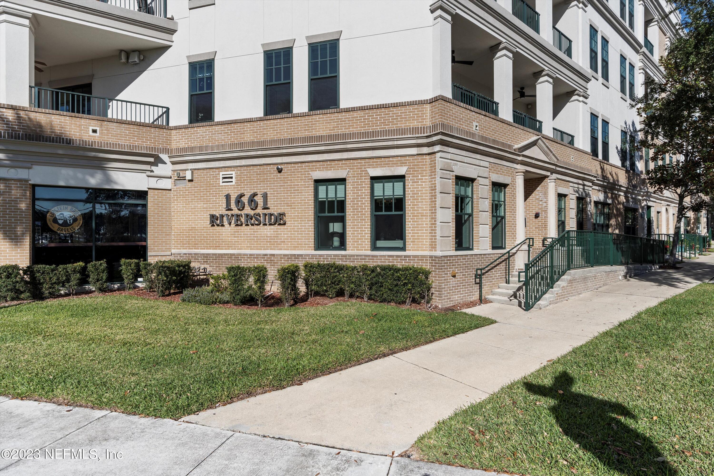 1661 Riverside Avenue, Unit 211 Jacksonville, FL 32204 - Photo 1 of 32 a front view of a building with garden