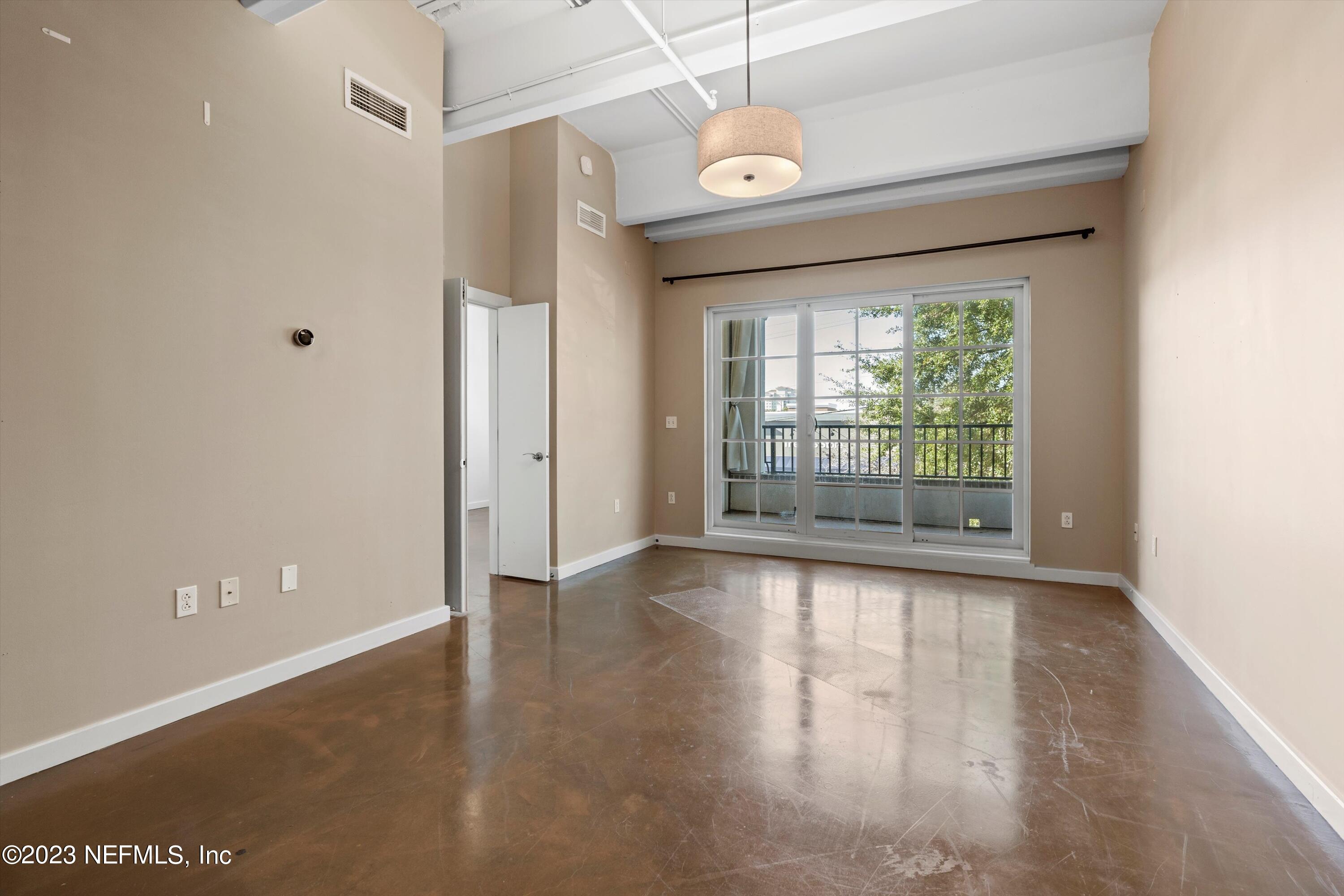 1661 Riverside Avenue, Unit 211 Jacksonville, FL 32204 - Photo 27 of 32 a view of an empty room with wooden floor and a window