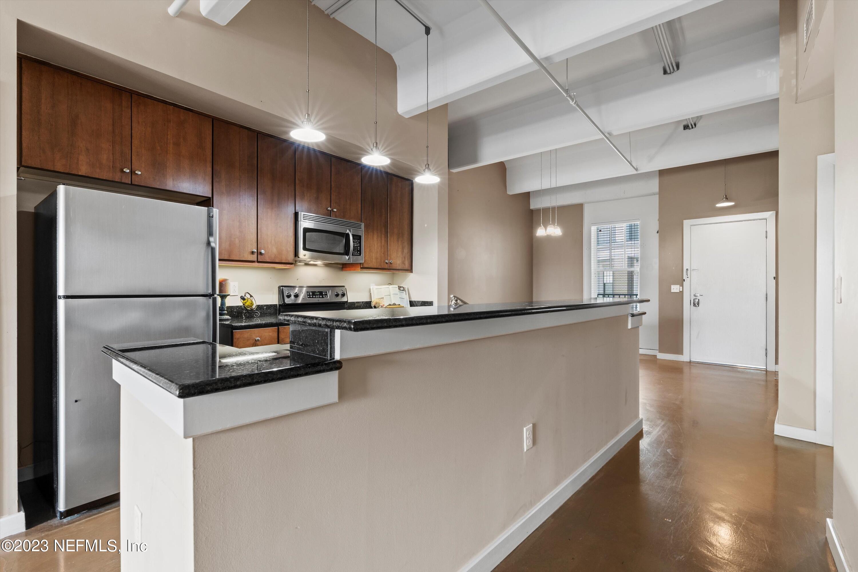 1661 Riverside Avenue, Unit 211 Jacksonville, FL 32204 - Photo 29 of 32 a kitchen with stainless steel appliances granite countertop a refrigerator a stove and a sink