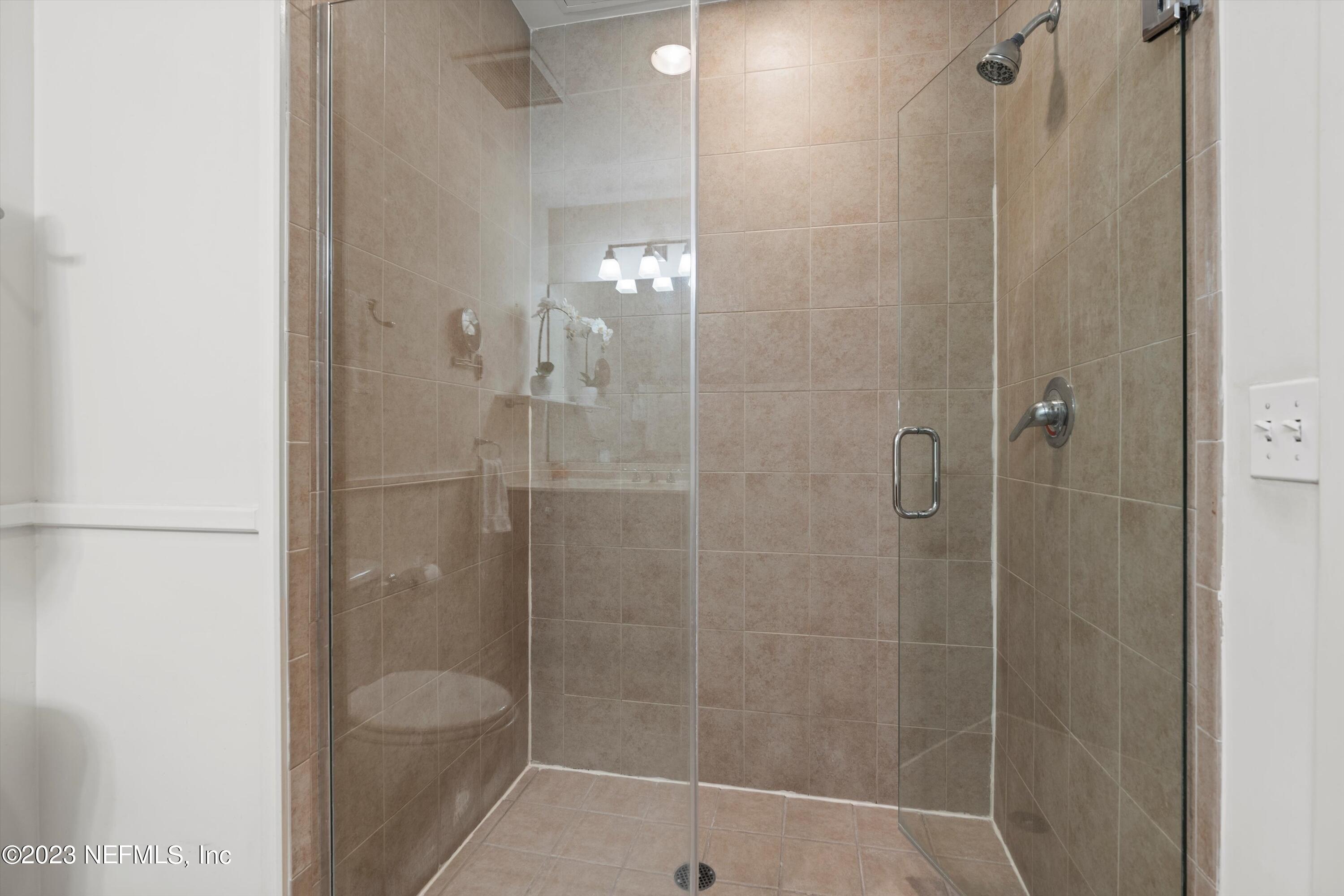 1661 Riverside Avenue, Unit 211 Jacksonville, FL 32204 - Photo 9 of 32 a bathroom with a shower and toilet