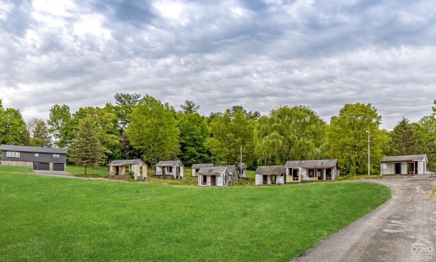 875 Road 23B Leeds, NY 12451 - Photo 3 of 38 a green field with lots of trees in the background