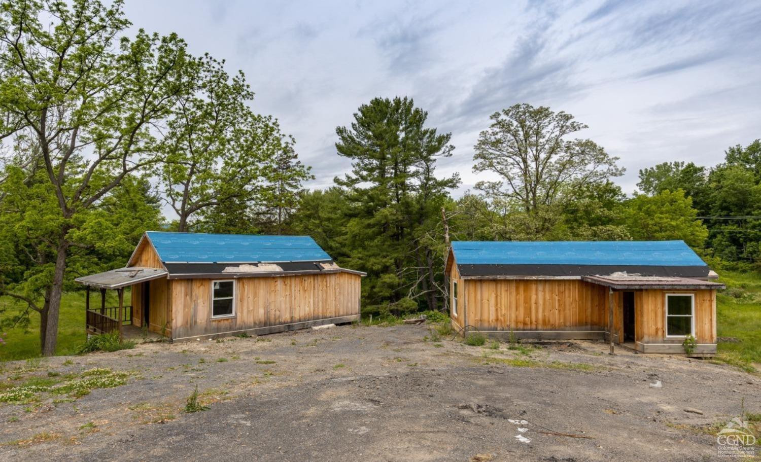875 Road 23B Leeds, NY 12451 - Photo 7 of 38 a front view of a house with a yard and a garage
