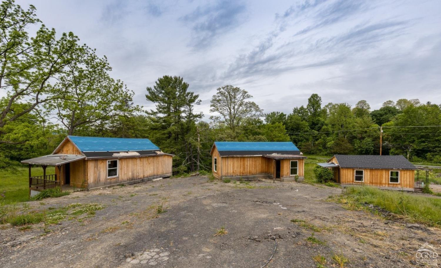 875 Road 23B Leeds, NY 12451 - Photo 8 of 38 a front view of a house with a yard and a garage