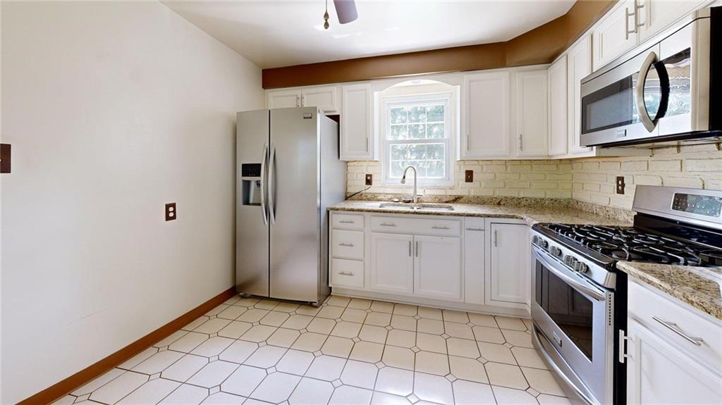 121 Rosemont Drive Coraopolis, PA 15108 - Photo 3 of 29 a kitchen with a stove a sink and a refrigerator