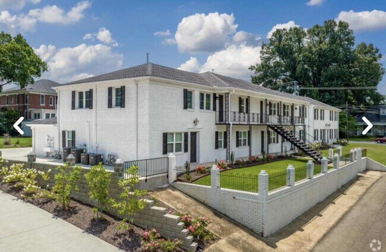 a view of a house with pool and chairs
