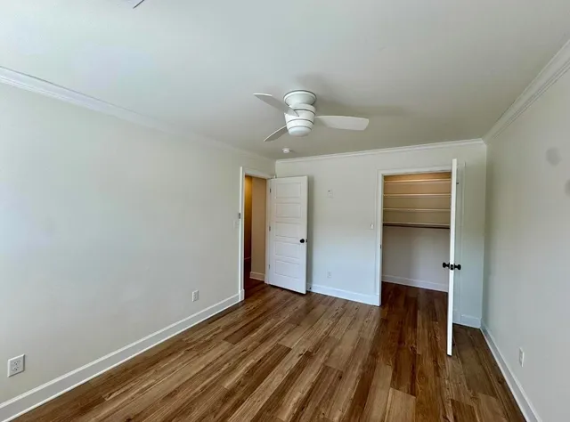 a view of empty room with wooden floor
