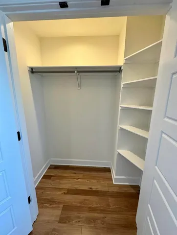 a view of walk in closet with empty racks
