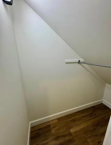 a view of a room with wooden floor