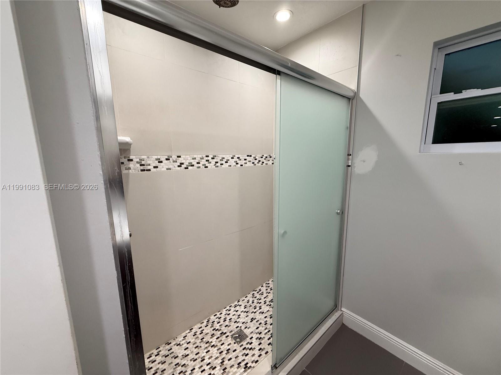 5488 Fearnley Road Lake Worth, FL 33467 - Photo 11 of 40 a bathroom with a shower and a sink