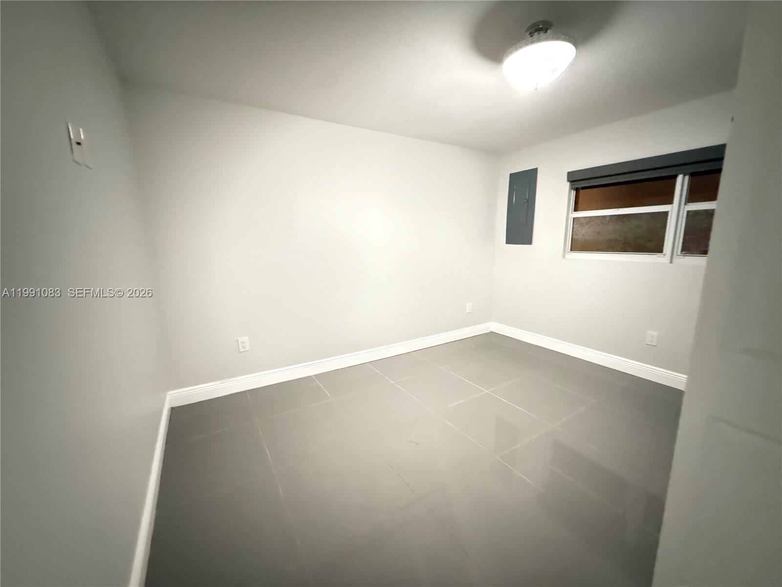 5488 Fearnley Road Lake Worth, FL 33467 - Photo 13 of 40 an empty room with a workbench