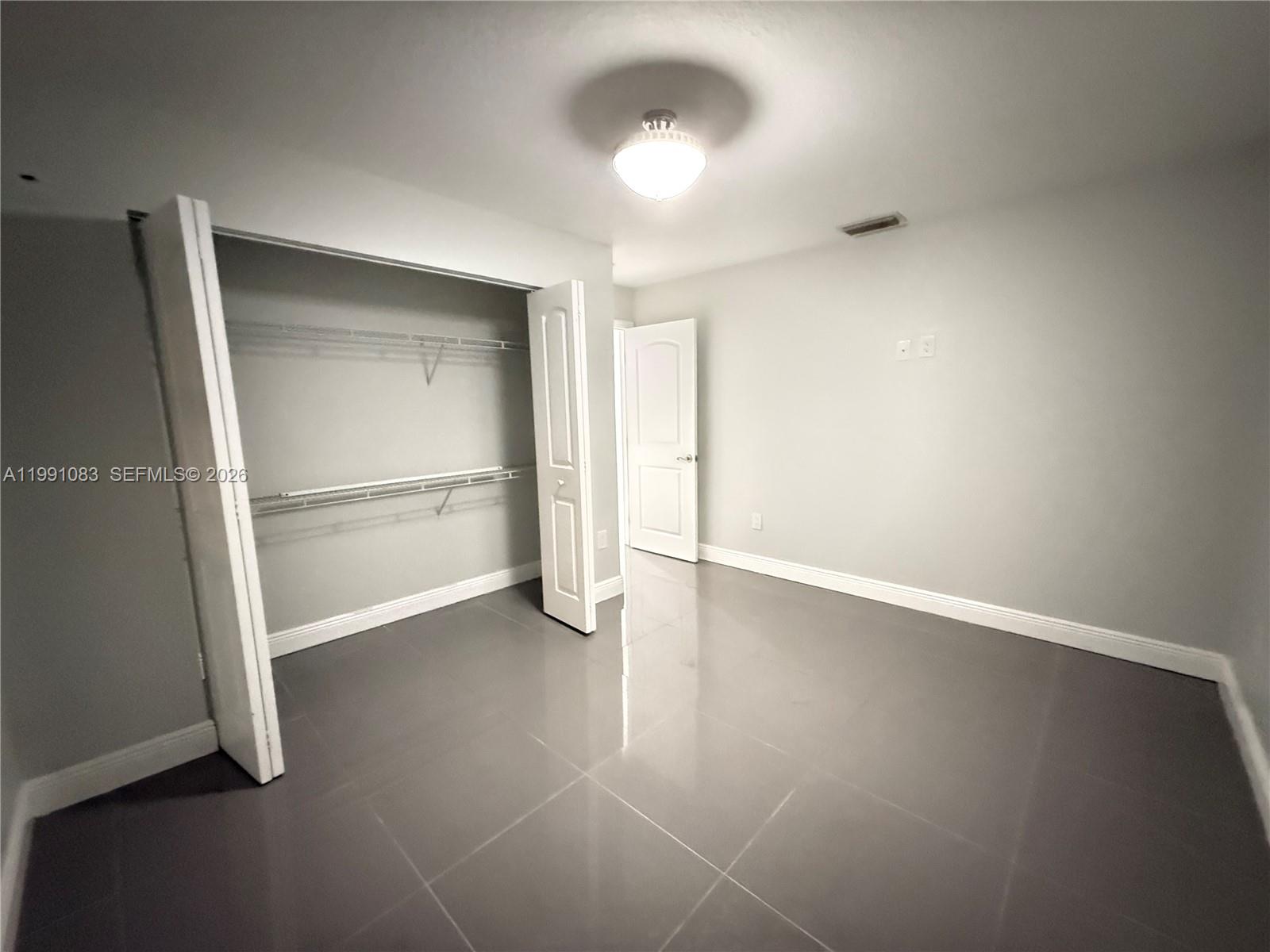 5488 Fearnley Road Lake Worth, FL 33467 - Photo 14 of 40 a view of an empty room with a window