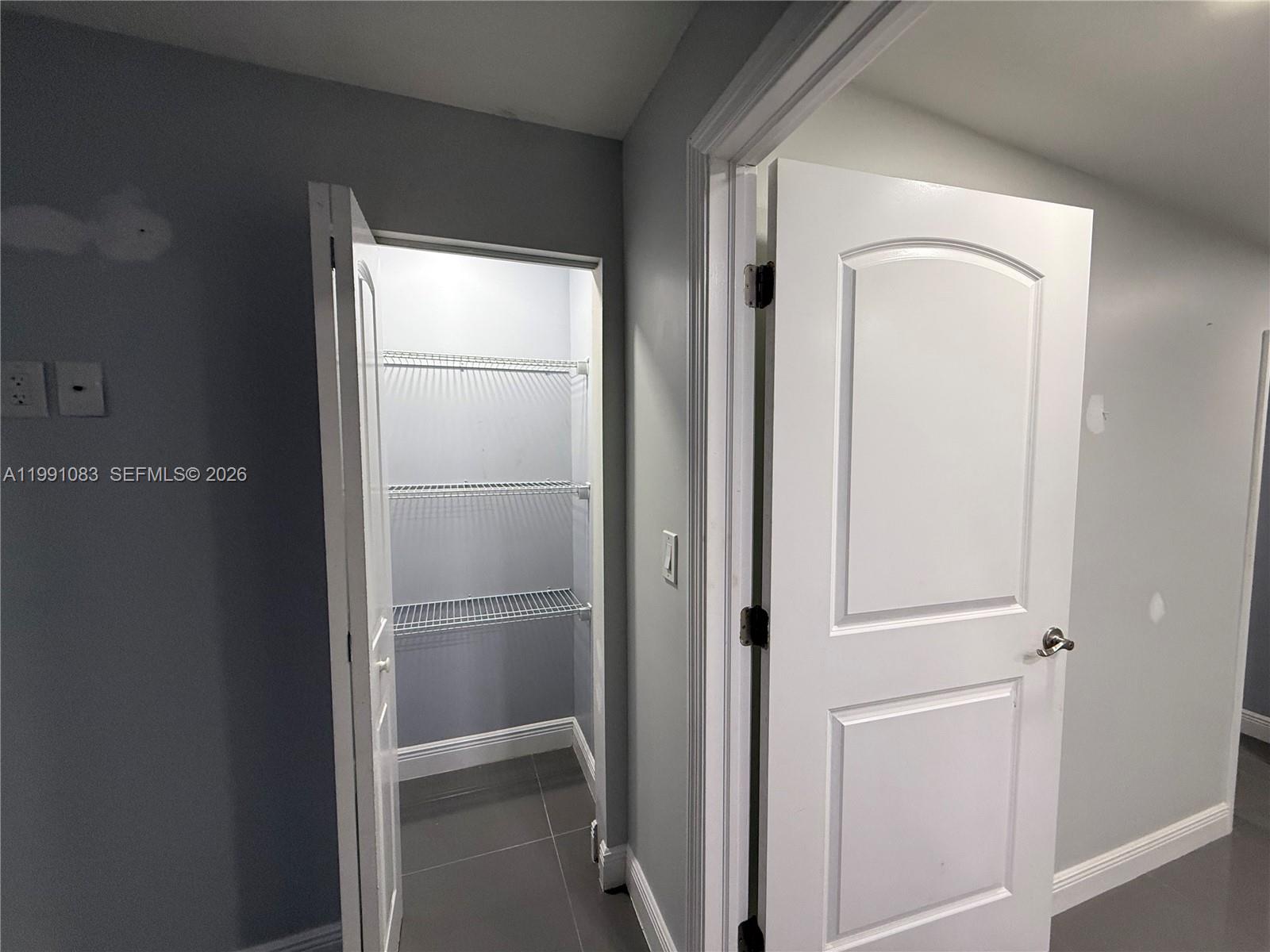 5488 Fearnley Road Lake Worth, FL 33467 - Photo 16 of 40 a bathroom with a glass shower door