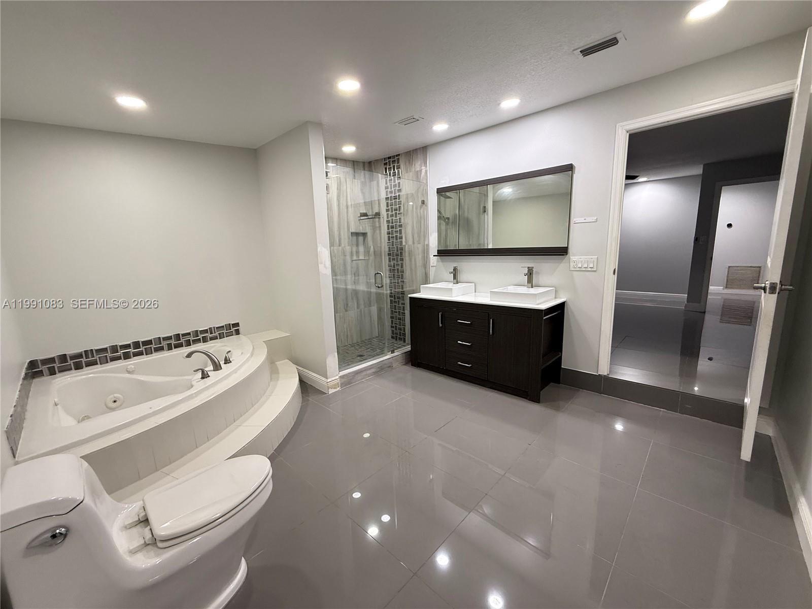 5488 Fearnley Road Lake Worth, FL 33467 - Photo 18 of 40 a bathroom with a sink and mirror