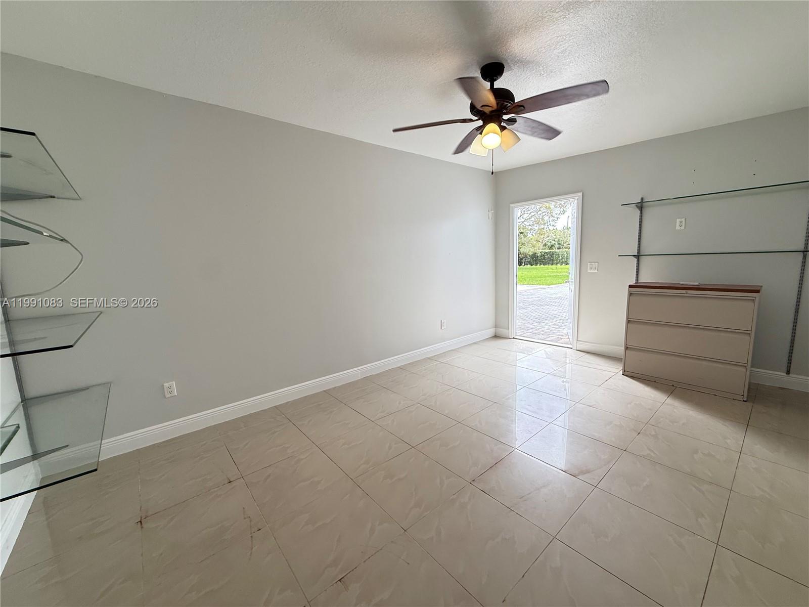 5488 Fearnley Road Lake Worth, FL 33467 - Photo 26 of 40 a view of a livingroom with a ceiling fan and window