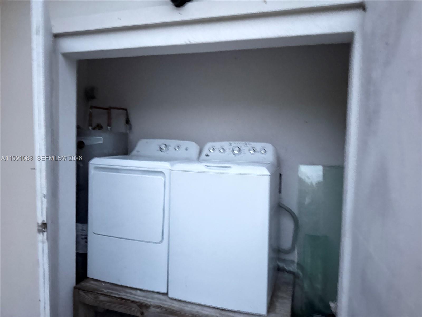 5488 Fearnley Road Lake Worth, FL 33467 - Photo 34 of 40 a utility room with dryer and washer