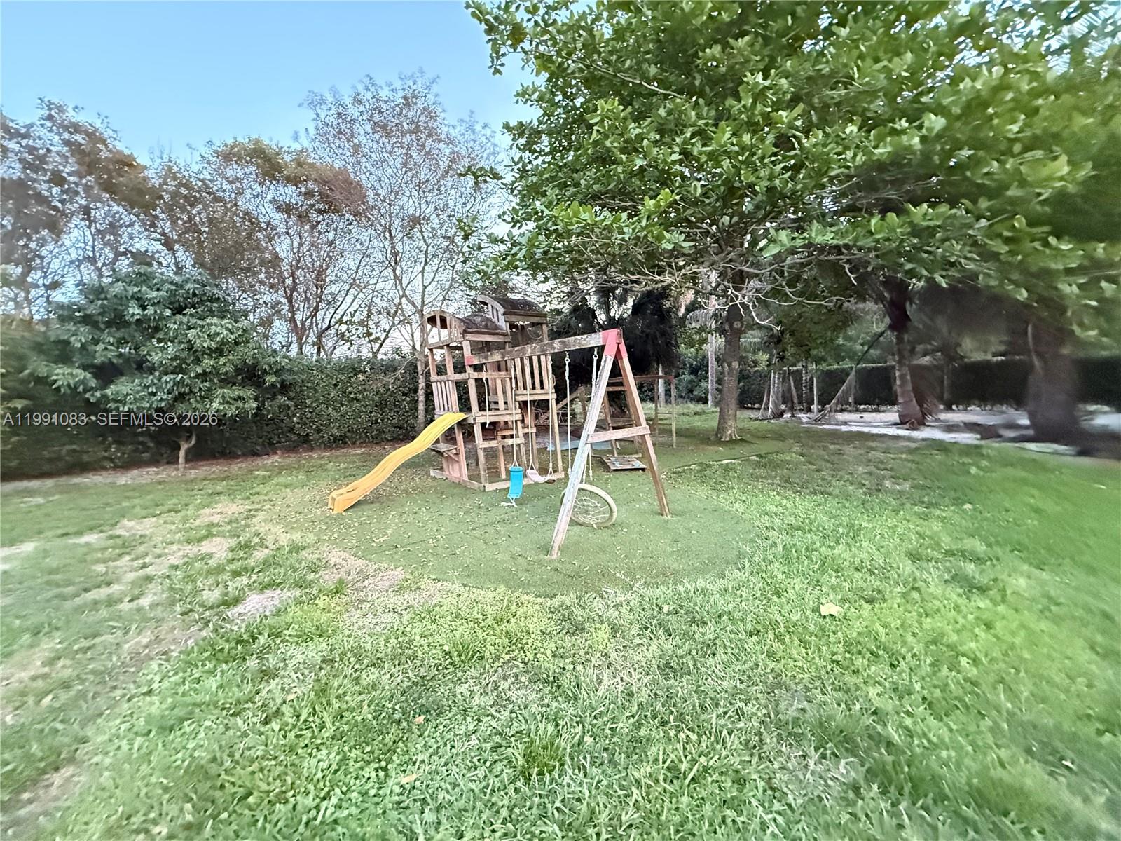 5488 Fearnley Road Lake Worth, FL 33467 - Photo 38 of 40 a view of a house with a backyard and a slide