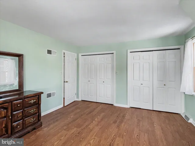 a view of a room with wooden floor and cabinet