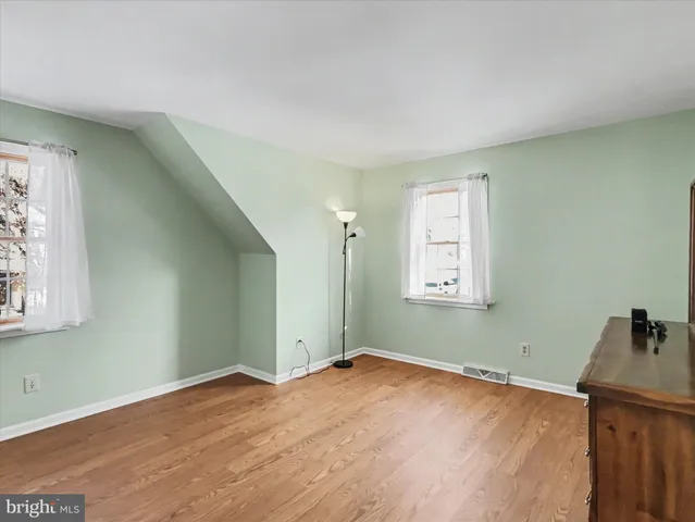 a view of a room with wooden floor and windows
