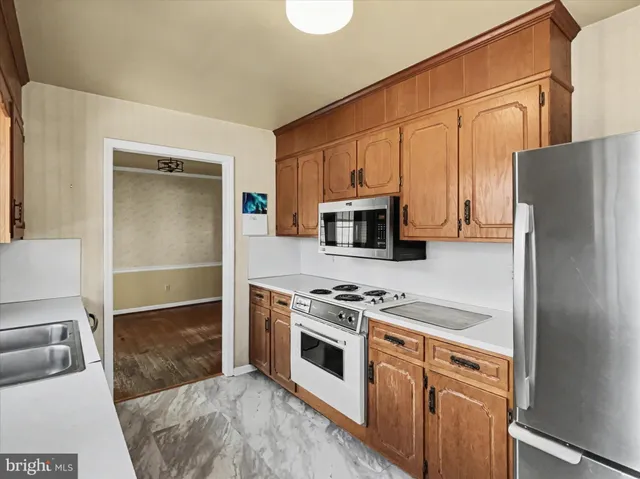 a kitchen with a refrigerator stove and microwave