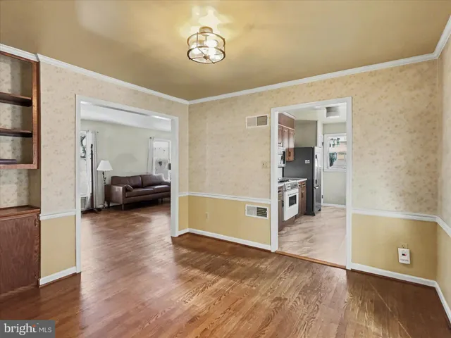 a view of a hallway view with wooden floor and furniture