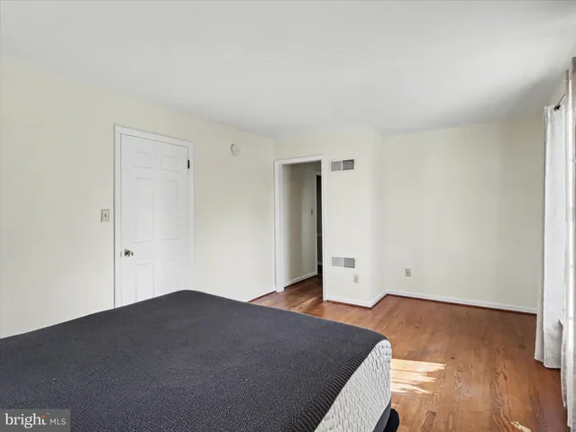 an empty room with wooden floor