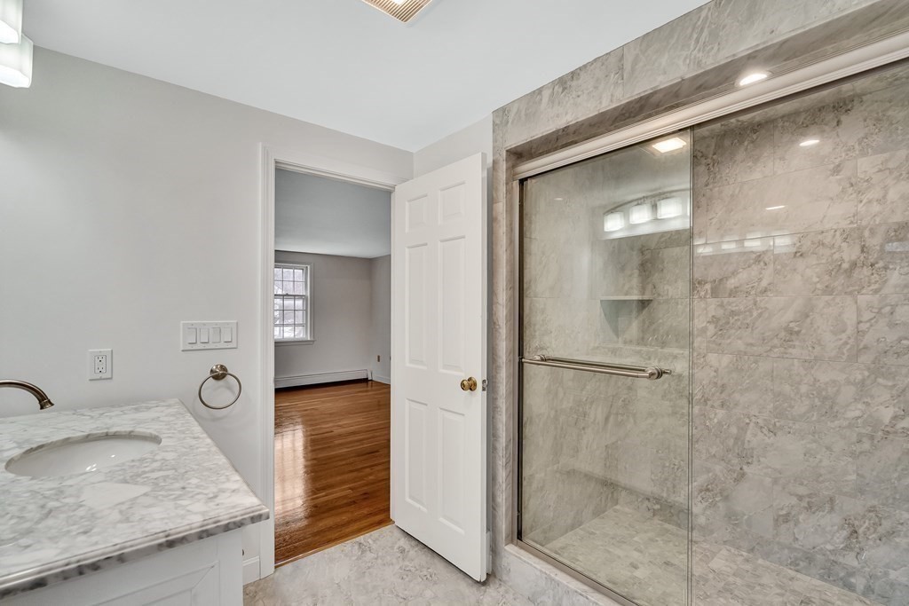 16 Nickerson Road Lexington, MA 02421 - Photo 11 of 41 a en suite bathroom with a granite countertop sink and a mirror