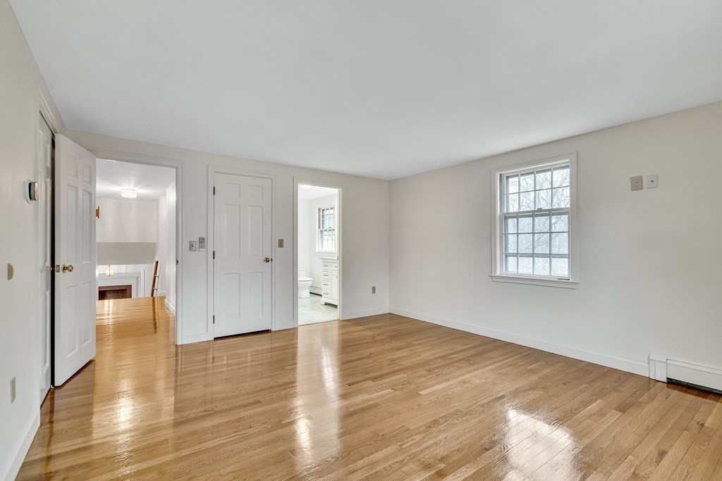 16 Nickerson Road Lexington, MA 02421 - Photo 13 of 41 a view of an empty room with wooden floor and a window