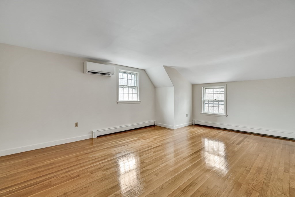 16 Nickerson Road Lexington, MA 02421 - Photo 16 of 41 an empty room with wooden floor and windows