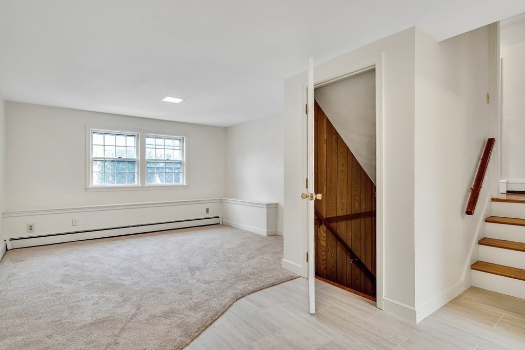 16 Nickerson Road Lexington, MA 02421 - Photo 23 of 41 a view of an empty room with wooden floor and stairs