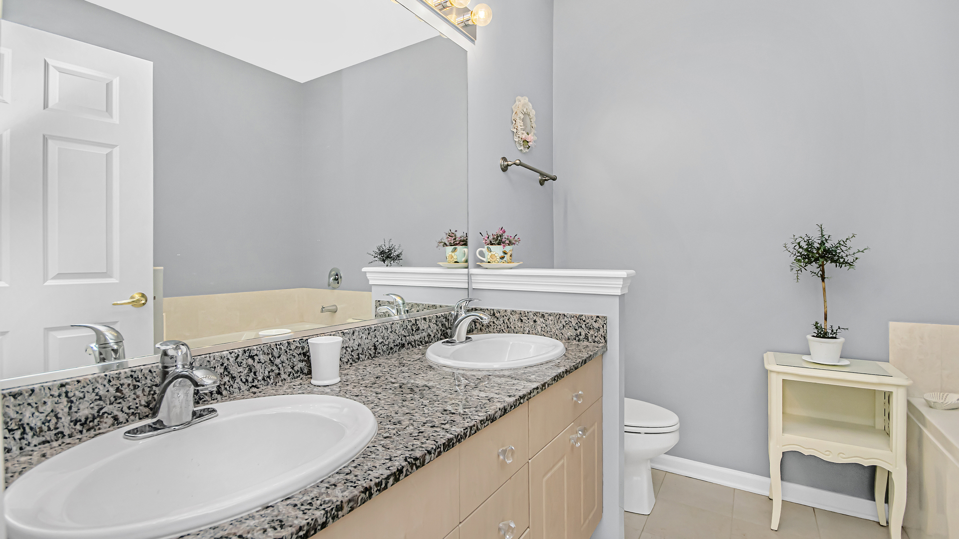 7738 North Sheridan Road, Unit 4L Chicago, IL 60626 - Photo 16 of 30 a bathroom with a granite countertop sink and a mirror