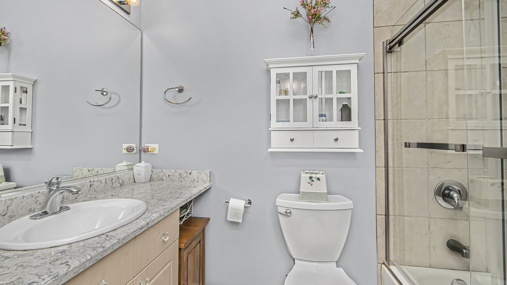 7738 North Sheridan Road, Unit 4L Chicago, IL 60626 - Photo 18 of 30 a bathroom with a granite countertop sink a toilet and shower