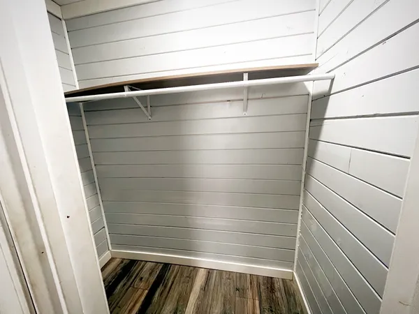 a kitchen with granite countertop a sink a stove cabinets and wooden floor