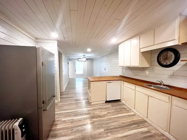 a view of a room with wooden floor