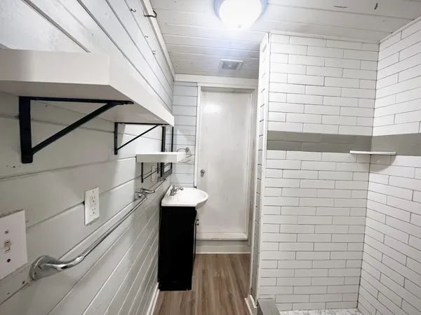 a kitchen with stainless steel appliances granite countertop a sink stove refrigerator and cabinets