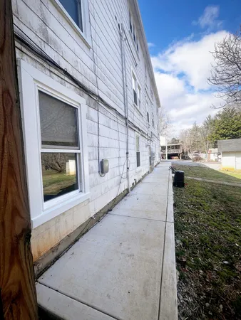 a view of a house with a yard covered in snow