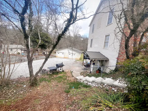 a backyard of a house with table and chairs