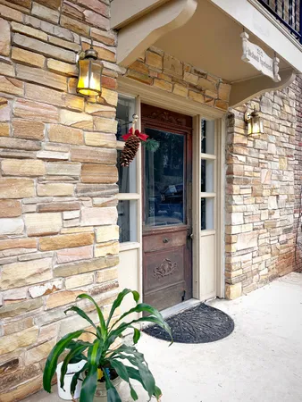 a view of a brick building with a door and a window