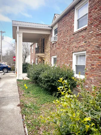 a view of a house with swimming pool and sitting area