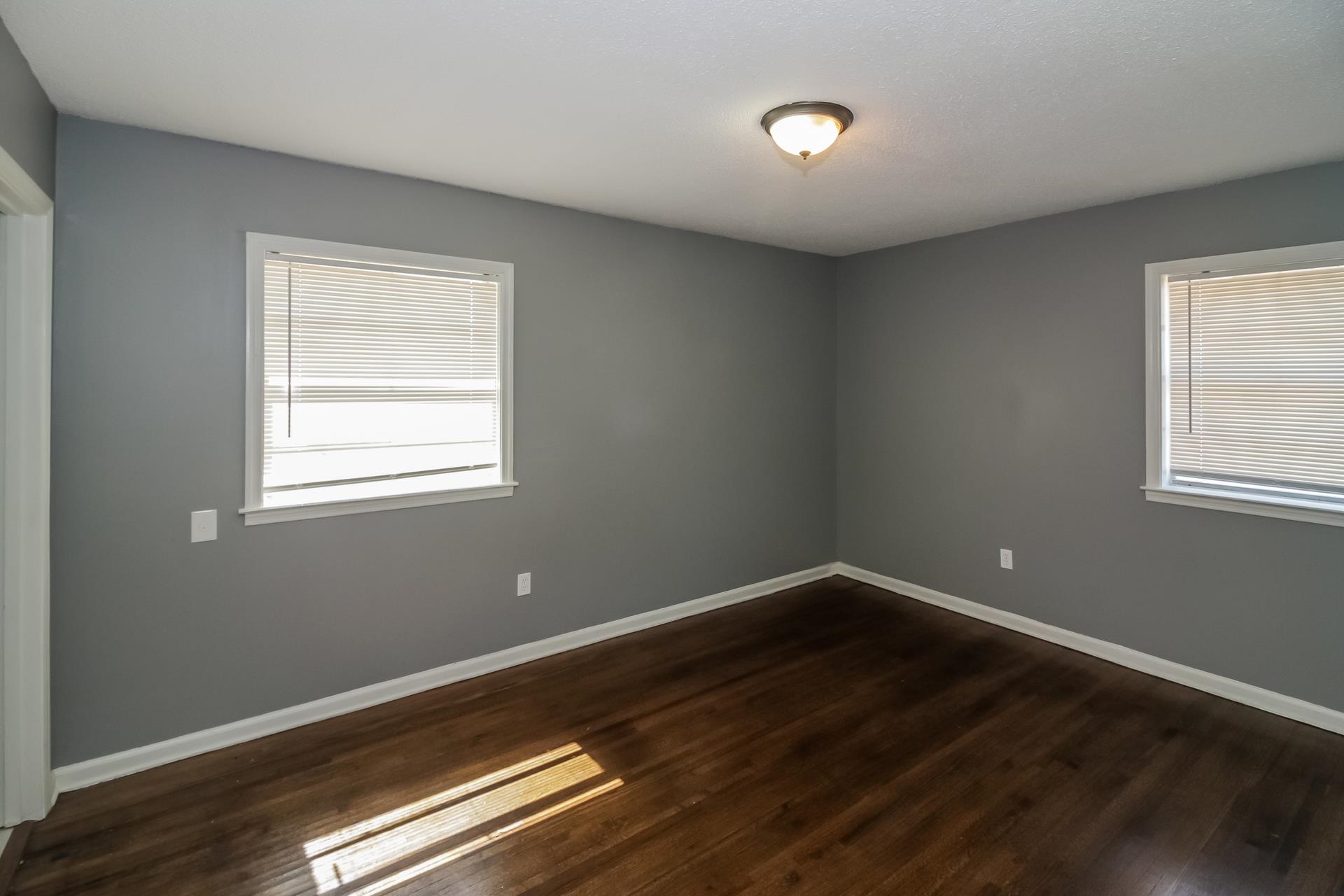 4559 Cottonwood Road Memphis, TN 38118 - Photo 15 of 16 Spare room featuring dark wood-style flooring