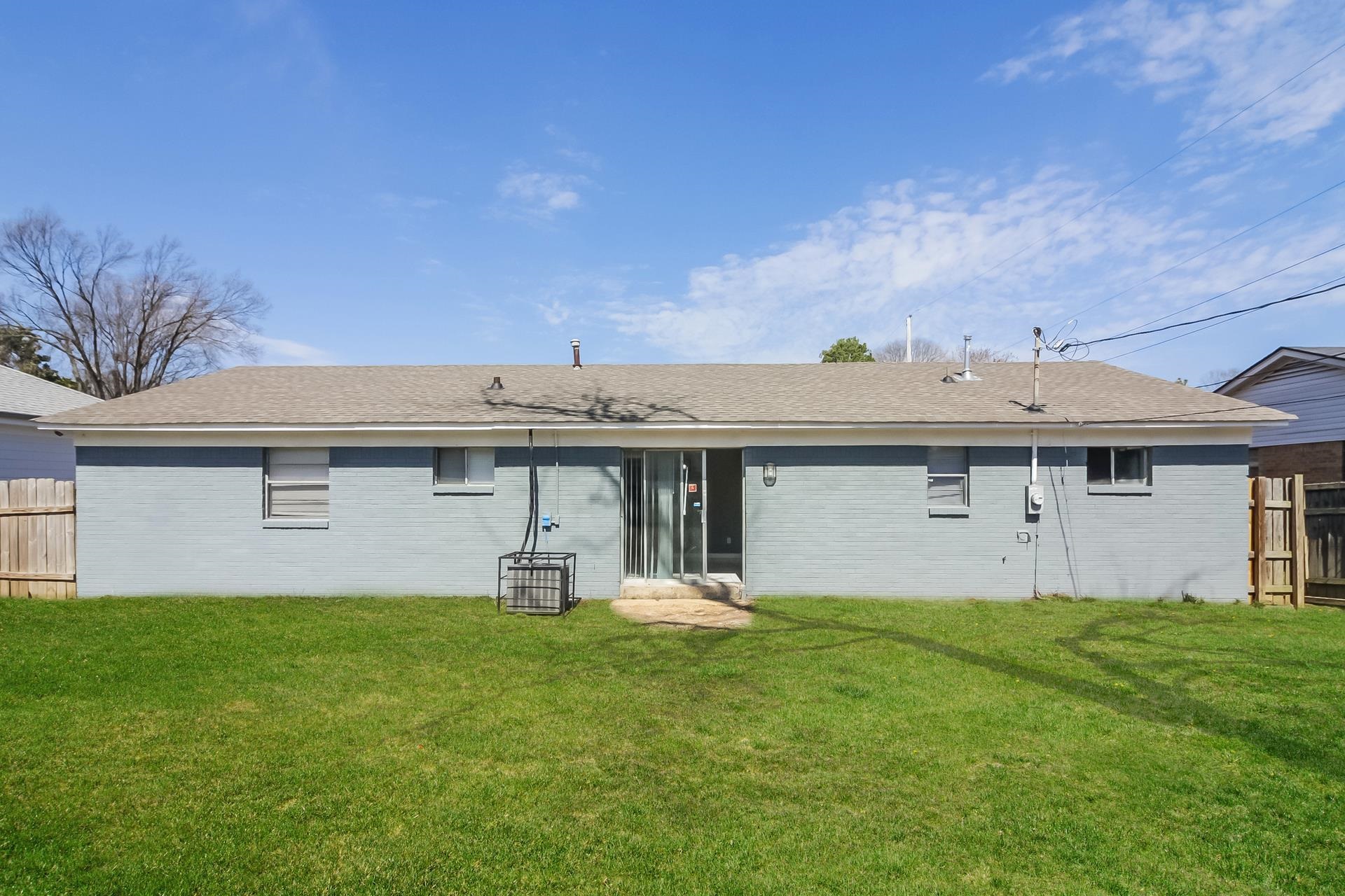 4559 Cottonwood Road Memphis, TN 38118 - Photo 8 of 16 Rear view of property featuring brick siding and a shingled roof