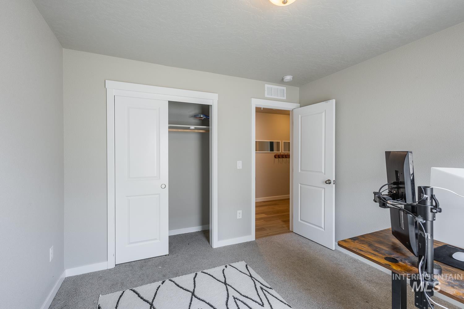 12623 Shadow Peak Street Caldwell, ID 83607 - Photo 40 of 50 Neutral gray wall paint and gray carpet flooring create a versatile interior