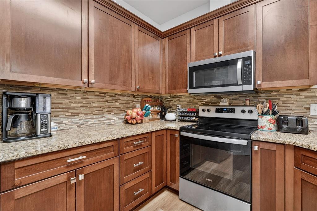 30 Deer Trail Circle Bronson, FL 32621 - Photo 12 of 55 a kitchen with granite countertop a stove sink and cabinets