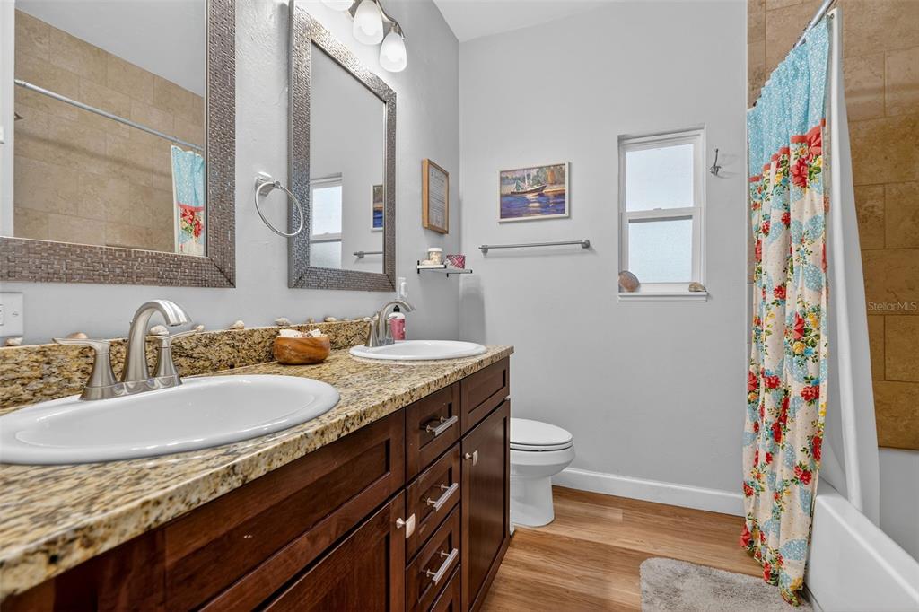 30 Deer Trail Circle Bronson, FL 32621 - Photo 19 of 55 a bathroom with a granite countertop sink and a mirror