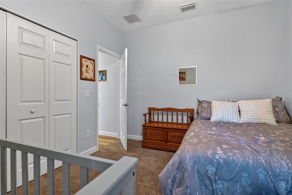 30 Deer Trail Circle Bronson, FL 32621 - Photo 24 of 55 a bedroom with a bed and a night stand
