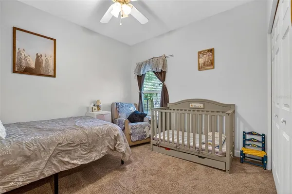 a bedroom with bed and a chandelier