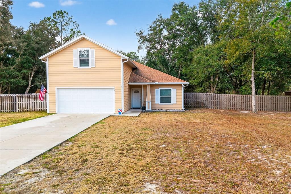 30 Deer Trail Circle Bronson, FL 32621 - Photo 55 of 55 a view of backyard of house with wooden deck and seating space