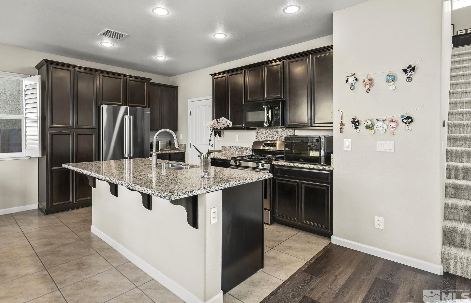 2055 Hope Valley Drive Reno, NV 89521 - Photo 2 of 21 a kitchen with stainless steel appliances granite countertop a stove a sink and a refrigerator